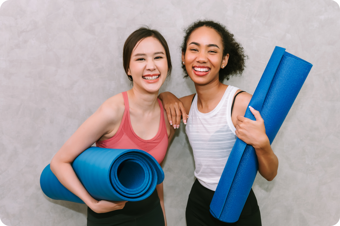 friend holding yoga mats