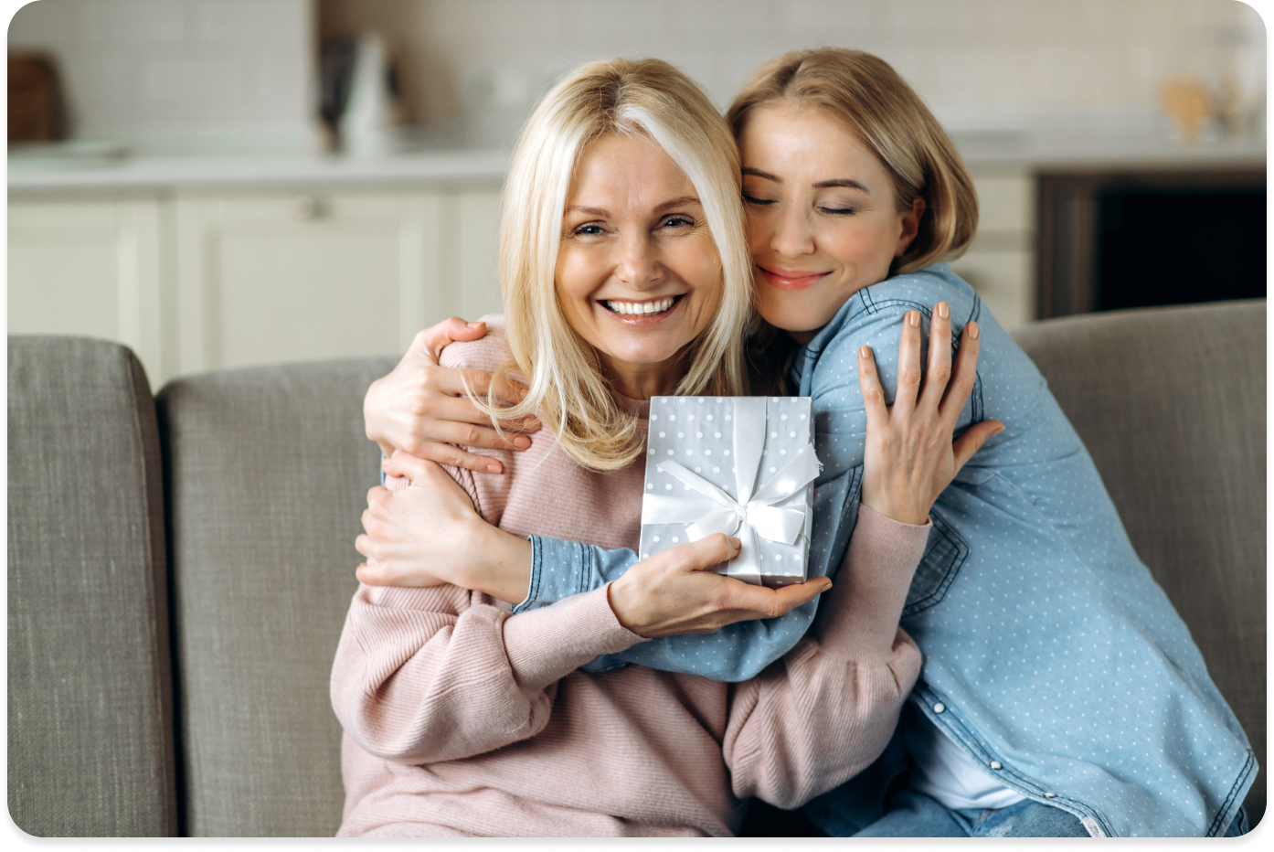 Daughter gifting mother a gift